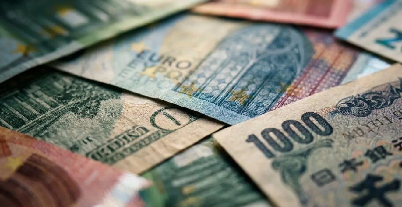 Macro shot of multiple international currency notes overlapping with selective focus