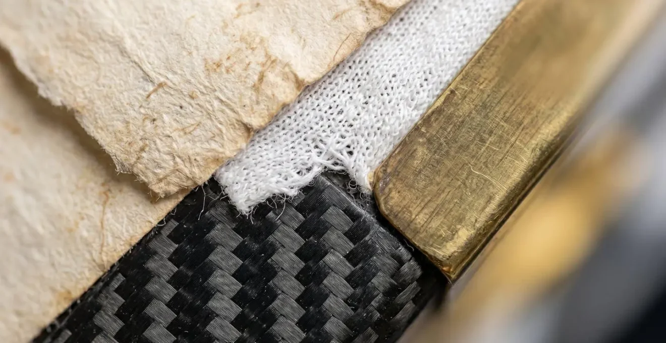 Close-up macro shot of interwoven heritage materials symbolizing integration of old and new.