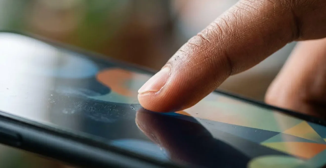 Close-up of hands testing mobile interface with accessible touch zones